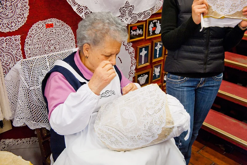 A lacemaker working by hand in a Burano lace shop