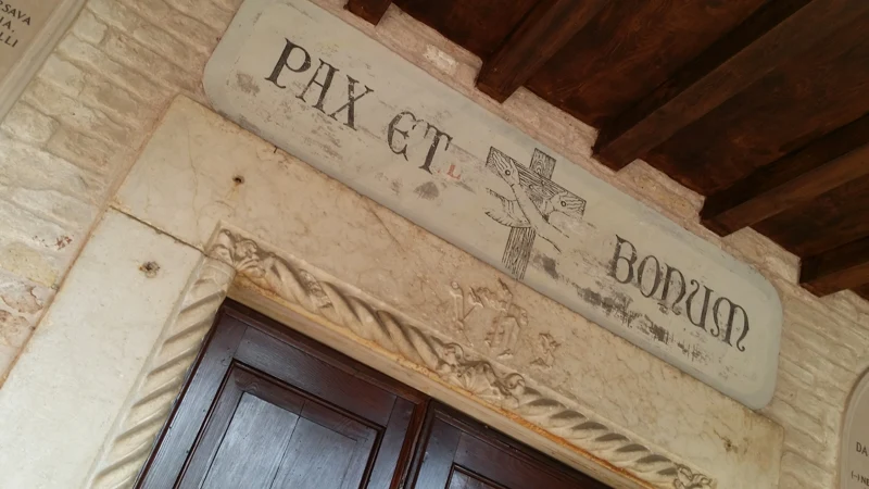 The Pax et Bonum inscription at the entrance to the San Francesco del Deserto monastery