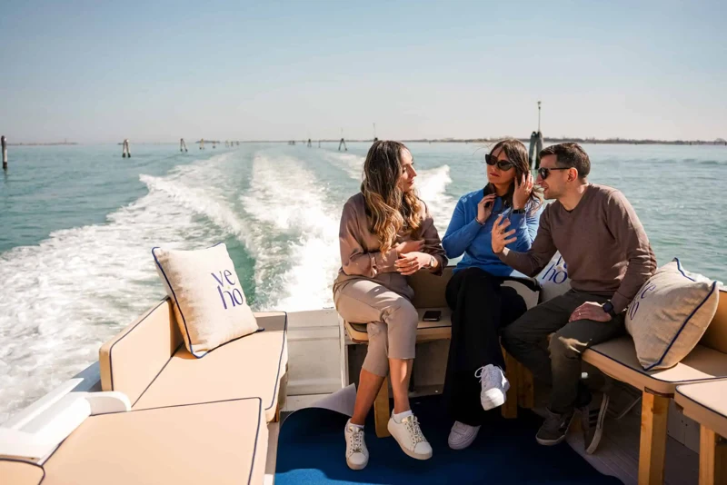 Guests aboard a Venice Hospitality boat cruising through the lagoon